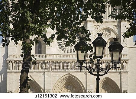 Stock Image - Lamp post in front of cathedral. Fotosearch