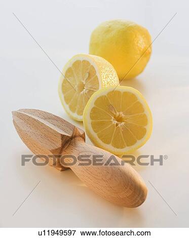 Stock Photo - Lemon halves and hand juicer. Fotosearch