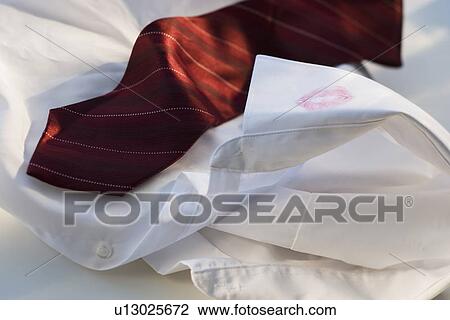 Lipstick on collar of button down shirt next to tie View Large Photo Image Stock Image - Lipstick on collar of button down shirt next to tie. Fotosearch