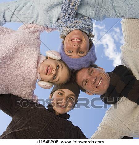 Low angle view of family in huddle View Large Photo Image Stock Photo - Low angle view of family in huddle. Fotosearch