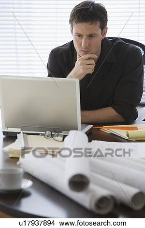 Male architect looking at laptop View Large Photo Image Picture - Male architect looking at laptop. Fotosearch