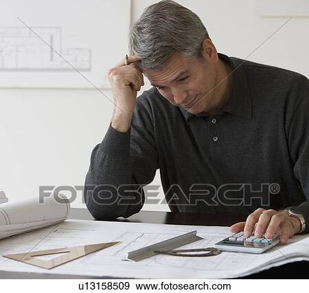 Stock Photo - Male architect working at desk. Fotosearch