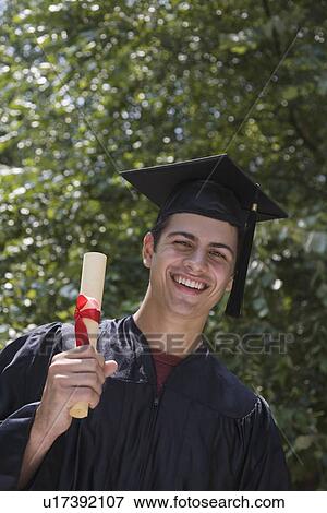 Stock Photo - Male college graduate holding diploma. Fotosearch