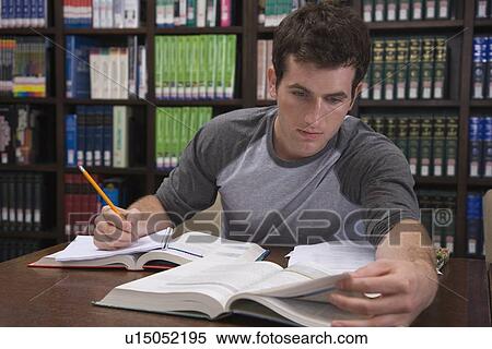 Male college student studying in library View Large Photo Image Stock Photography - Male college student studying in library. Fotosearch