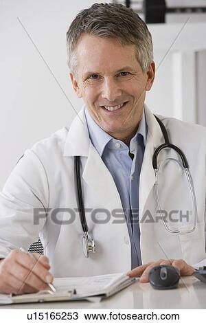 Male doctor writing on chart View Large Photo Image Stock Image - Male doctor writing on chart. Fotosearch