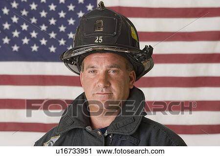 Male firefighter in front of American flag View Large Photo Image Stock Image - Male firefighter in front of American flag. Fotosearch