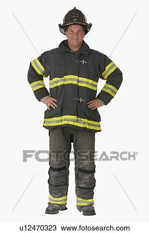 Stock Image - Male firefighter with hands on hips. Fotosearch