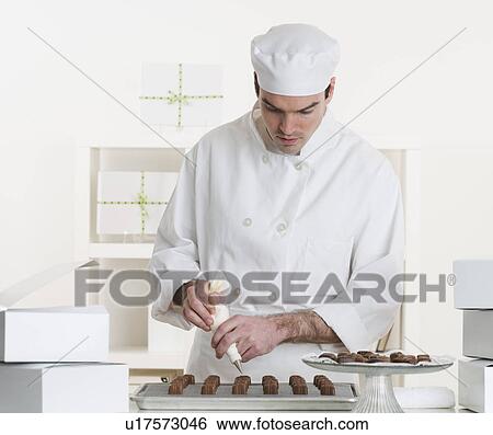 Stock Photograph - Male pastry chef in kitchen. Fotosearch