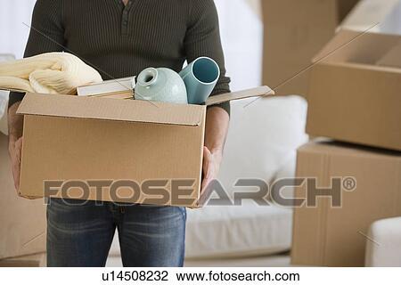 Man carrying moving box View Large Photo Image Stock Image - Man carrying moving box. Fotosearch