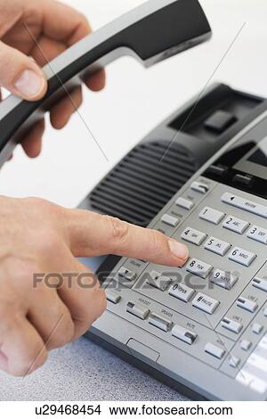 Man dialing telephone View Large Photo Image Picture - Man dialing telephone. Fotosearch