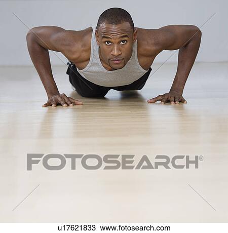 Man doing pushups indoors View Large Photo Image Stock Image - Man doing pushups indoors. Fotosearch