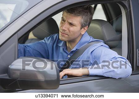 Stock Image - Man driving car. Fotosearch