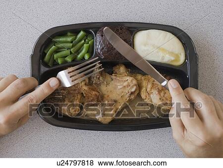 Man eating TV dinner View Large Photo Image Stock Photo - Man eating TV dinner. Fotosearch