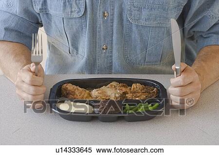 Man eating TV dinner View Large Photo Image Stock Photography - Man eating TV dinner. Fotosearch