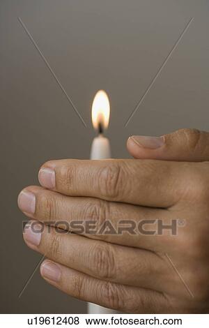 Man holding hand in front of candle View Large Photo Image Stock Photo - Man holding hand in front of candle. Fotosearch