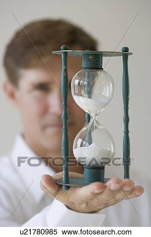 Man holding hourglass View Large Photo Image Stock Photography - Man holding hourglass. Fotosearch