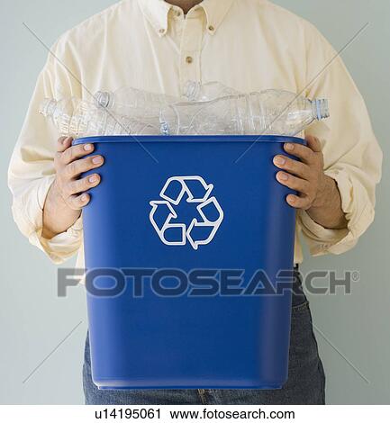 Man holding recycling bin View Large Photo Image Stock Image - Man holding recycling bin. Fotosearch