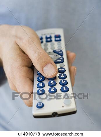 Man holding remote control View Large Photo Image Stock Photo - Man holding remote control. Fotosearch