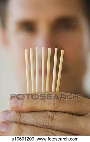 Man holding toothpicks View Large Photo Image Stock Photo - Man holding toothpicks. Fotosearch