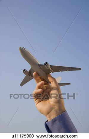 Man holding toy airplane View Large Photo Image Stock Image - Man holding toy airplane. Fotosearch