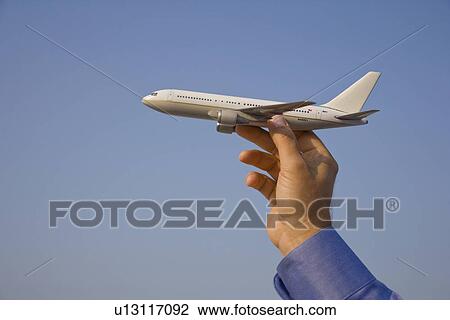 Man holding toy airplane View Large Photo Image Stock Image - Man holding toy airplane. Fotosearch