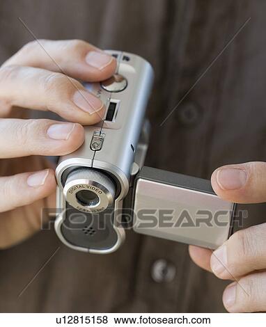 Man holding video camera View Large Photo Image Stock Photo - Man holding video camera. Fotosearch