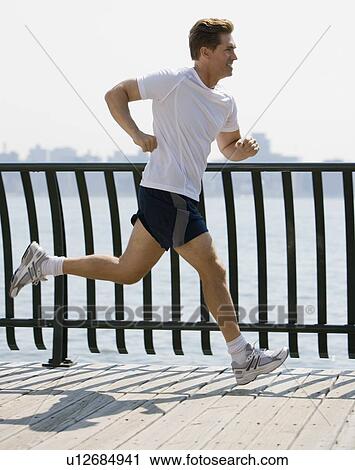 Man jogging in urban area View Large Photo Image Stock Image - Man jogging in urban area. Fotosearch