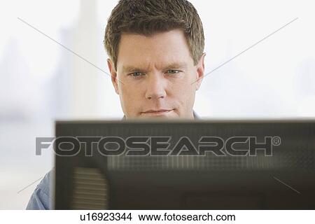 Man looking at computer screen View Large Photo Image Picture - Man looking at computer screen. Fotosearch