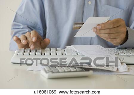 Stock Photo - Man paying bills. Fotosearch