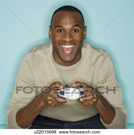 Stock Photo - Man playing video games. Fotosearch