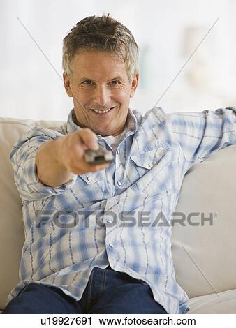 Man pointing television remote control View Large Photo Image Stock Image - Man pointing television remote control. Fotosearch