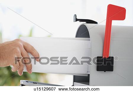 Stock Photo - Man putting mail in mailbox. Fotosearch