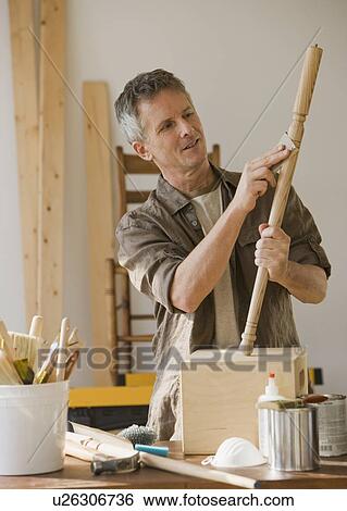 Stock Photograph - Man sanding piece of wood. Fotosearch
