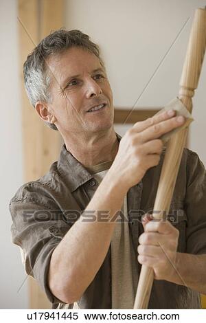 Man sanding piece of wood View Large Photo Image Stock Photography - Man sanding piece of wood. Fotosearch
