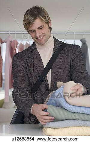Picture - Man shopping for clothing. Fotosearch
