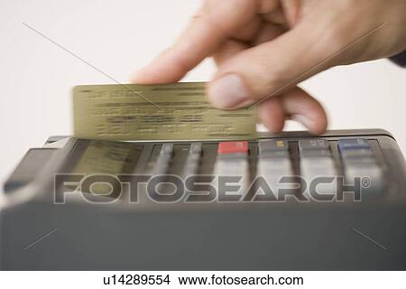 Man swiping credit card in credit card machine View Large Photo Image Picture - Man swiping credit card in credit card machine. Fotosearch