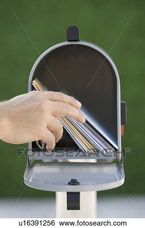 Man taking mail out of mailbox View Large Photo Image Stock Photograph - Man taking mail out of mailbox. Fotosearch