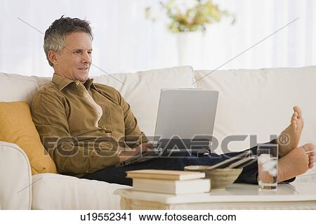 Stock Image - Man typing on laptop. Fotosearch