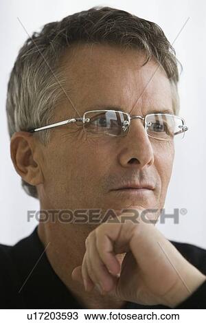 Stock Image - Man wearing eyeglasses. Fotosearch