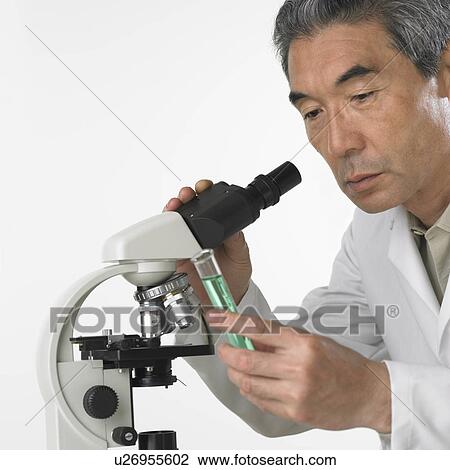Man with vial of fluid and microscope View Large Photo Image Stock Image - Man with vial of fluid and microscope. Fotosearch