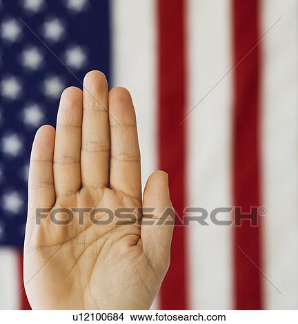 Man’s hand up in front of American flag View Large Photo Image Picture - Man’s hand up in front of American flag. Fotosearch