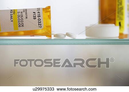 Medication bottle and pills on shelf View Large Photo Image Stock Image - Medication bottle and pills on shelf. Fotosearch