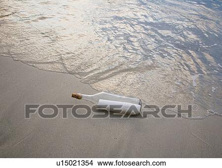 Picture - Message in bottle on beach. Fotosearch