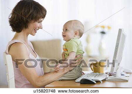 Mother and baby smiling at each other View Large Photo Image Stock Photo - Mother and baby smiling at each other. Fotosearch