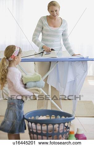 Mother and daughter doing laundry View Large Photo Image Stock Image - Mother and daughter doing laundry. Fotosearch