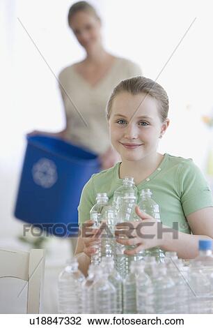 Mother and daughter filling recycle bin View Large Photo Image Stock Image - Mother and daughter filling recycle bin. Fotosearch