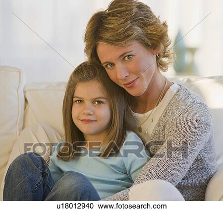 Stock Image - Mother and daughter hugging. Fotosearch