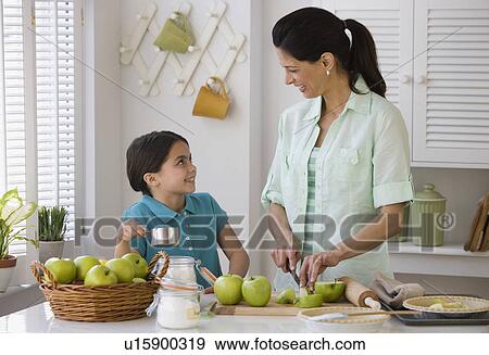 Mother and daughter making apple pie View Large Photo Image Stock Photo - Mother and daughter making apple pie. Fotosearch