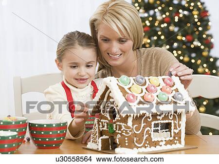 Mother and daughter making gingerbread house View Large Photo Image Picture - Mother and daughter making gingerbread house. Fotosearch