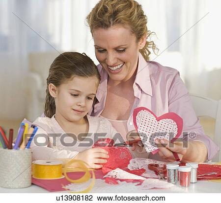Stock Image - Mother and daughter making Valentines. Fotosearch